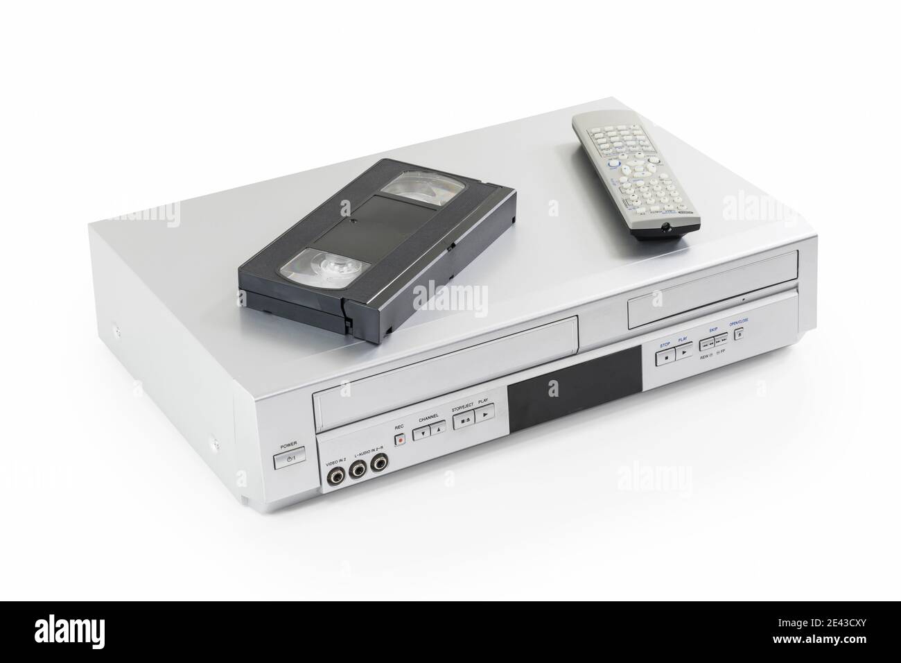Old video cassette and disk player machine with remote controller, on white. Stock Photo