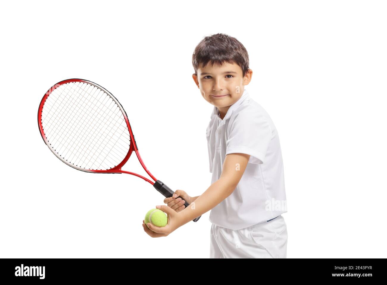 Boy serving a tennis ball with a racquet isolated on white background