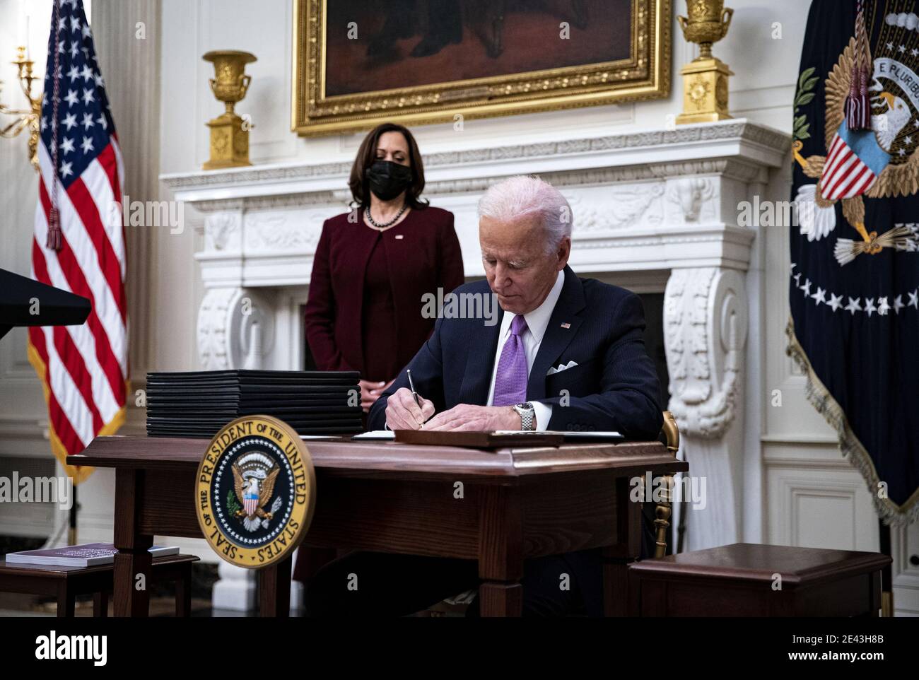 Washington, United States. 21st Jan, 2021. U.S. President Joe Biden signs an executive order during an event on his administration's Covid-19 response in the State Dining Room of the White House in Washington, DC, U.S., on Thursday, Jan. 21, 2021. Biden in his first full day in office plans to issue a sweeping set of executive orders to tackle the raging Covid-19 pandemic that will rapidly reverse or refashion many of his predecessor's most heavily criticized policies. Photo by Al Drago/UPI Credit: UPI/Alamy Live News Stock Photo