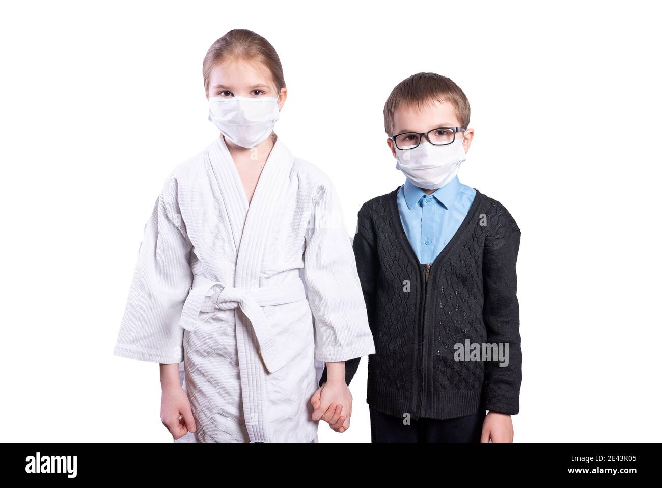 Schoolboy boy and girl athlete hold hands. Masked. Isolated on white background. High quality photo Stock Photo