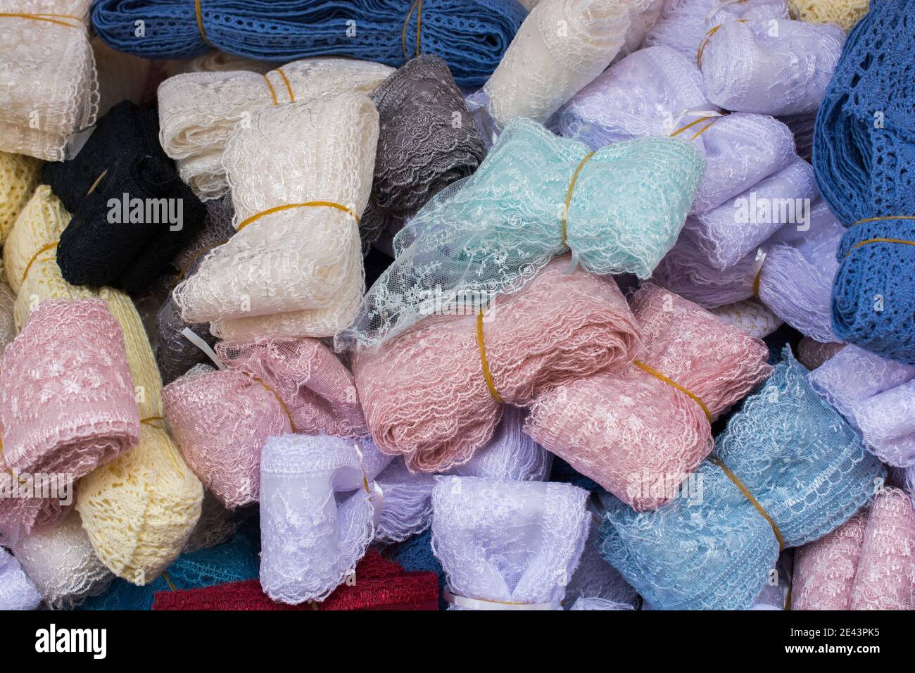 Pile of colorful embroidered lace ribbons captured in a market Stock Photo