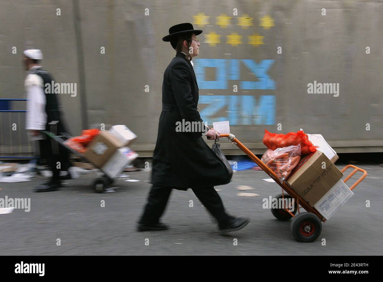 Ultra-Orthodox Jewish men carrie sacks of food for distribution to the needy, for the upcoming Jewish holiday of Passover, in the Mea Shearim neighbourhood of Jerusalem, Israel on April 6, 2009. Passover commemorates the flight of Jews from Ancient Egypt as described in Exodus. According to the account, the Jews did not have time to prepare leavened bread before fleeing to the Promised Land. Photo by Olivier Fitoussi/ABACAPRESS.COM Stock Photo