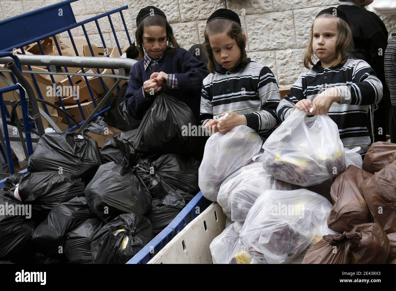 Ultra-Orthodox Jewish boys pack meat for distribution to the needy, for the upcoming Jewish holiday of Passover, in the Mea Shearim neighbourhood of Jerusalem, Israel on April 6, 2009. Passover commemorates the flight of Jews from Ancient Egypt as described in Exodus. According to the account, the Jews did not have time to prepare leavened bread before fleeing to the Promised Land. Photo by Olivier Fitoussi/ABACAPRESS.COM Stock Photo