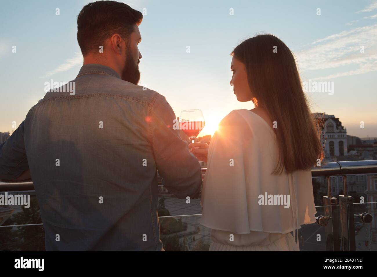 Woman watching sunset balcony hi-res stock photography and images - Alamy