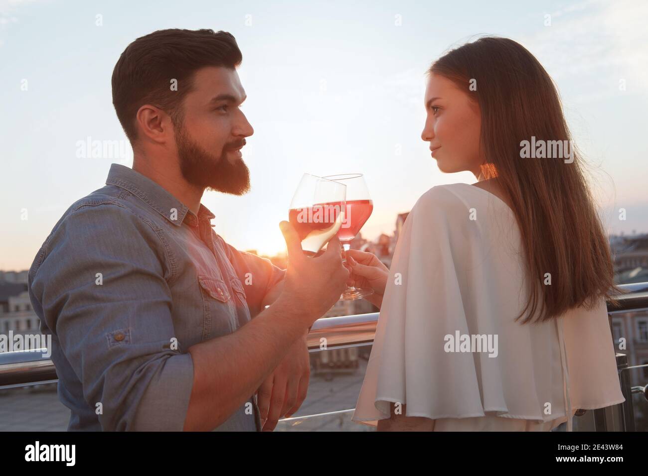 Woman watching sunset balcony hi-res stock photography and images - Alamy