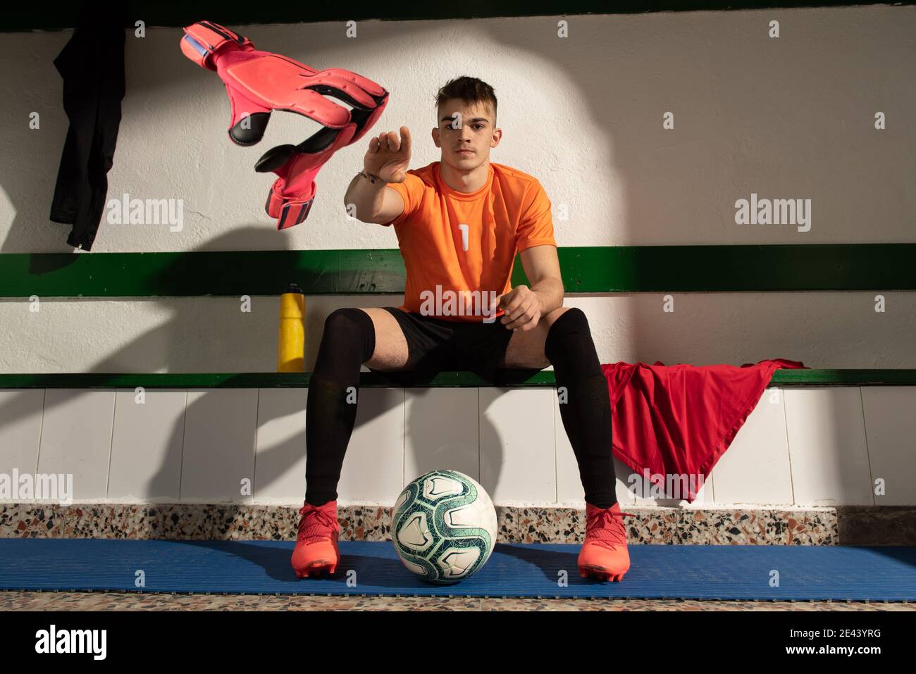 A football player in dressing room with sports uniform Stock Photo Alamy
