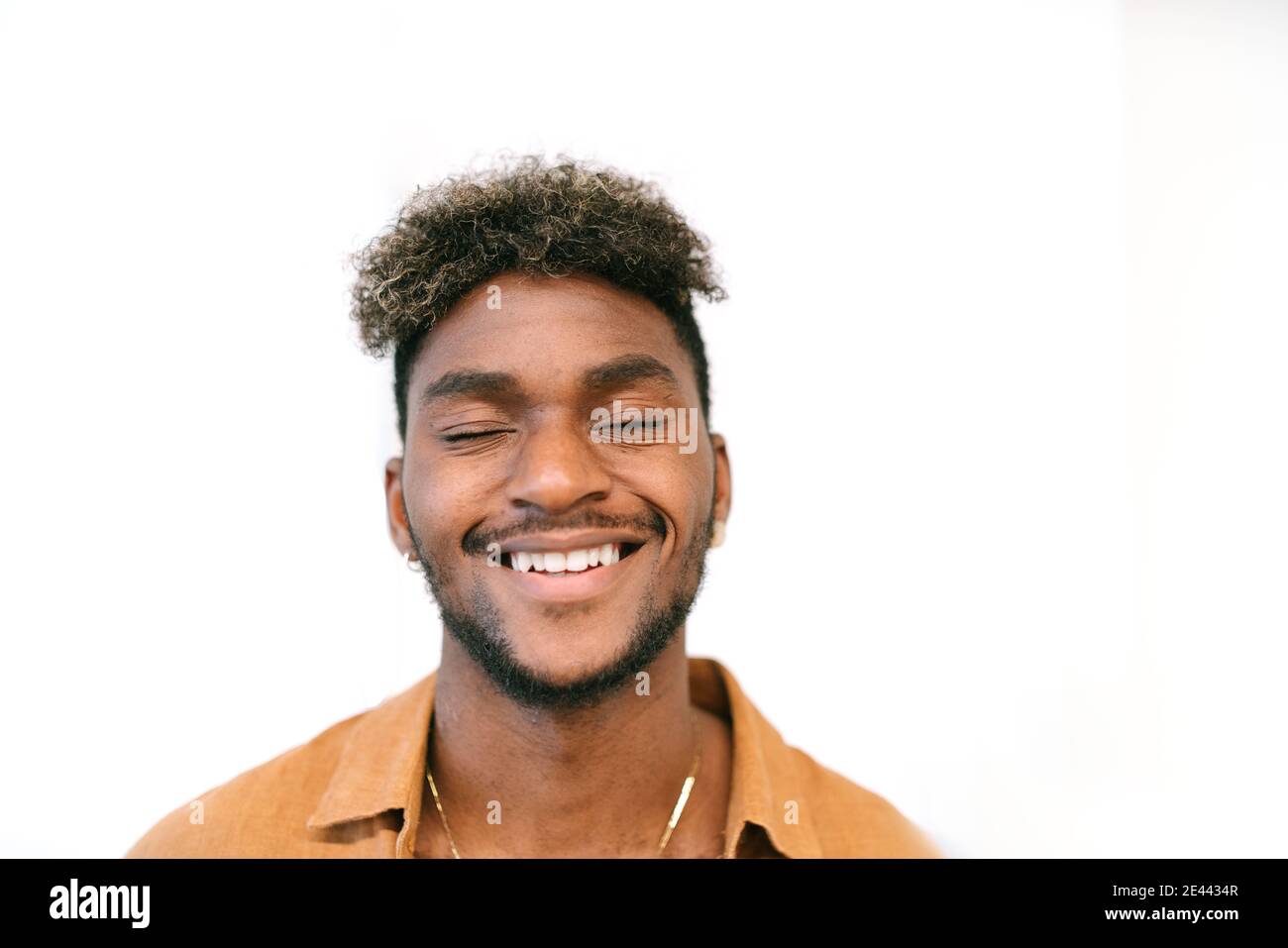 Handsome young bearded hipster black guy with curly hair Stock Photo