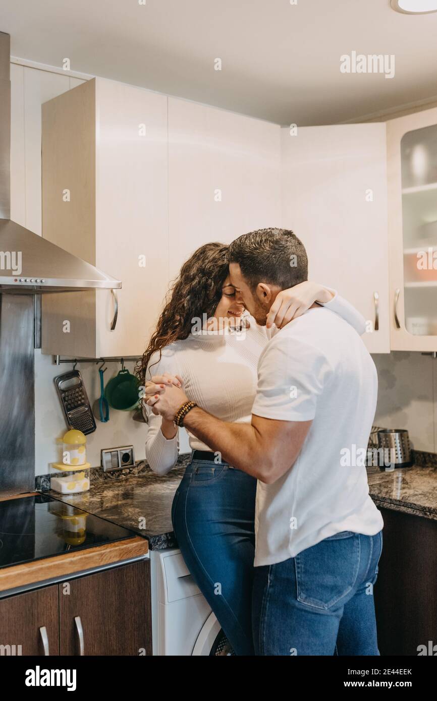 unrecognizable female cook adding spoonful of flour into bowl with fresh batter while preparing pastry on table with fresh citruses and juice Stock Photo