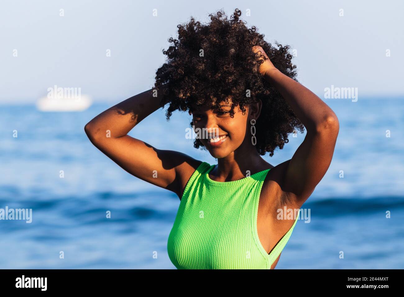 Cheerful beautiful African American female in swimsuit and with curly hair  standing in sea and having fun during summer vacation Stock Photo - Alamy