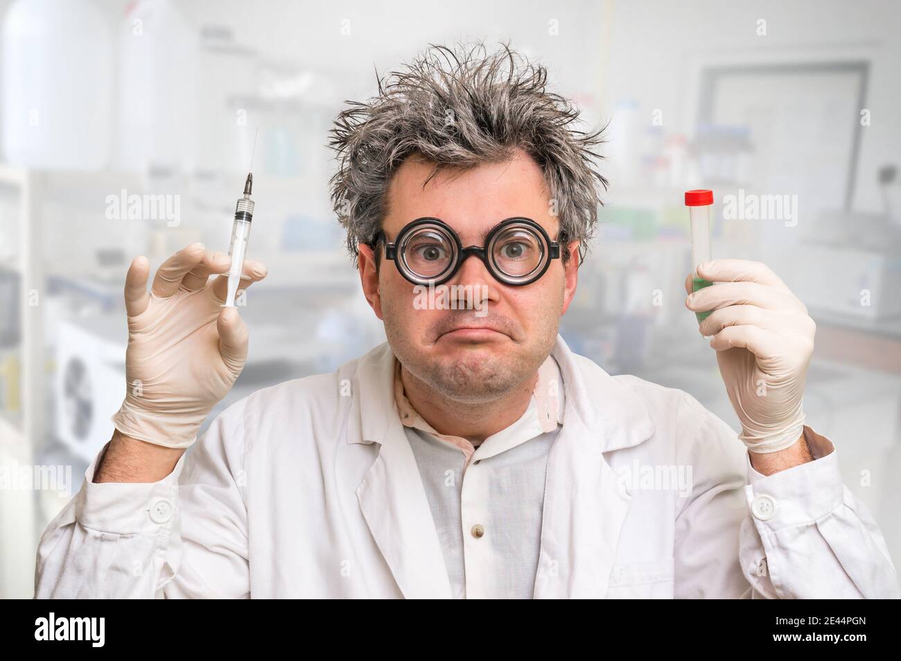 Crazy scientist with gray hair performing experiments in laboratory
