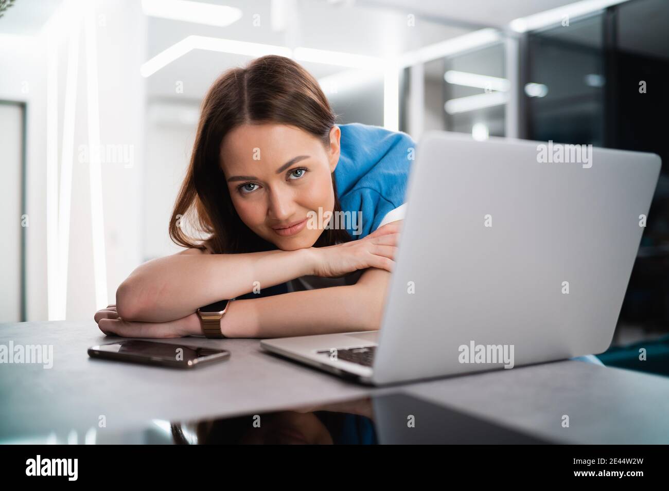 Portrait of happy successful caucasian woman in informal wear looking and smiling at the camera. Attractive female manager on self isolation after Stock Photo
