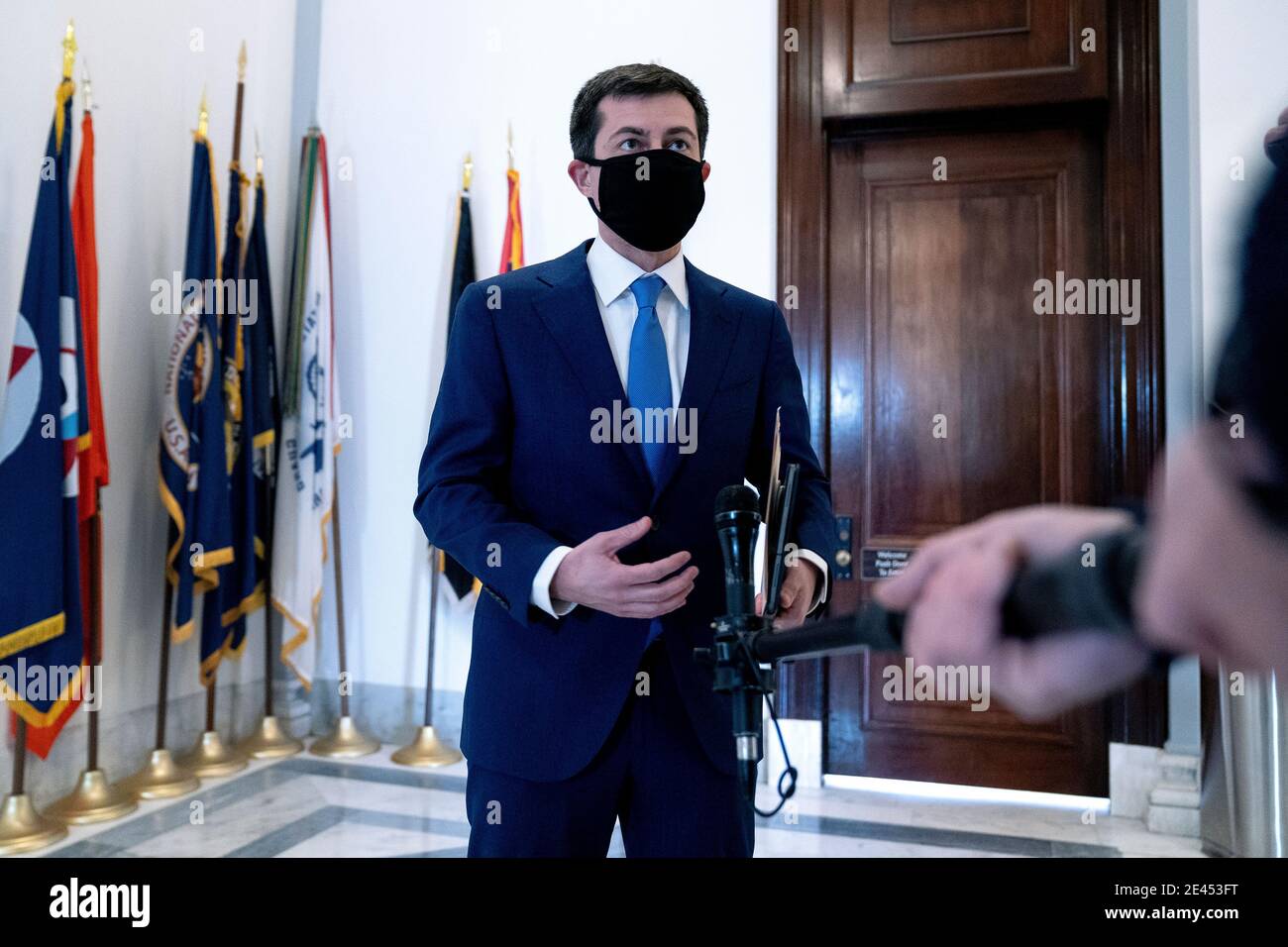 Pete Buttigieg, U.S. secretary of transportation nominee for U.S. President Joe Biden, wears a protective mask while speaking to members of the media after a Senate Commerce, Science and Transportation Committee confirmation hearing in Washington, DC, U.S., on Thursday, Jan. 21, 2021. Buttigieg, is pledging to carry out the administration's ambitious agenda to rebuild the nation's infrastructure, calling it a 'generational opportunity' to create new jobs, fight economic inequality and stem climate change. Credit: Stefani Reynolds/Pool via CNP | usage worldwide Stock Photo
