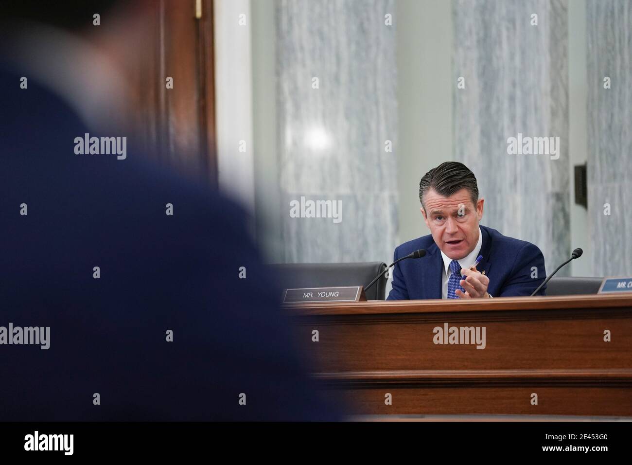 United States Senator Todd Young (Republican of Indiana), speaks as Pete Buttigieg, U.S. secretary of transportation nominee for U.S. President Joe Biden, left, listens during a Senate Commerce, Science and Transportation Committee confirmation hearing in Washington, DC, U.S., on Thursday, Jan. 21, 2021. Buttigieg, is pledging to carry out the administration's ambitious agenda to rebuild the nation's infrastructure, calling it a 'generational opportunity' to create new jobs, fight economic inequality and stem climate change. Credit: Stefani Reynolds/Pool via CNP | usage worldwide Stock Photo