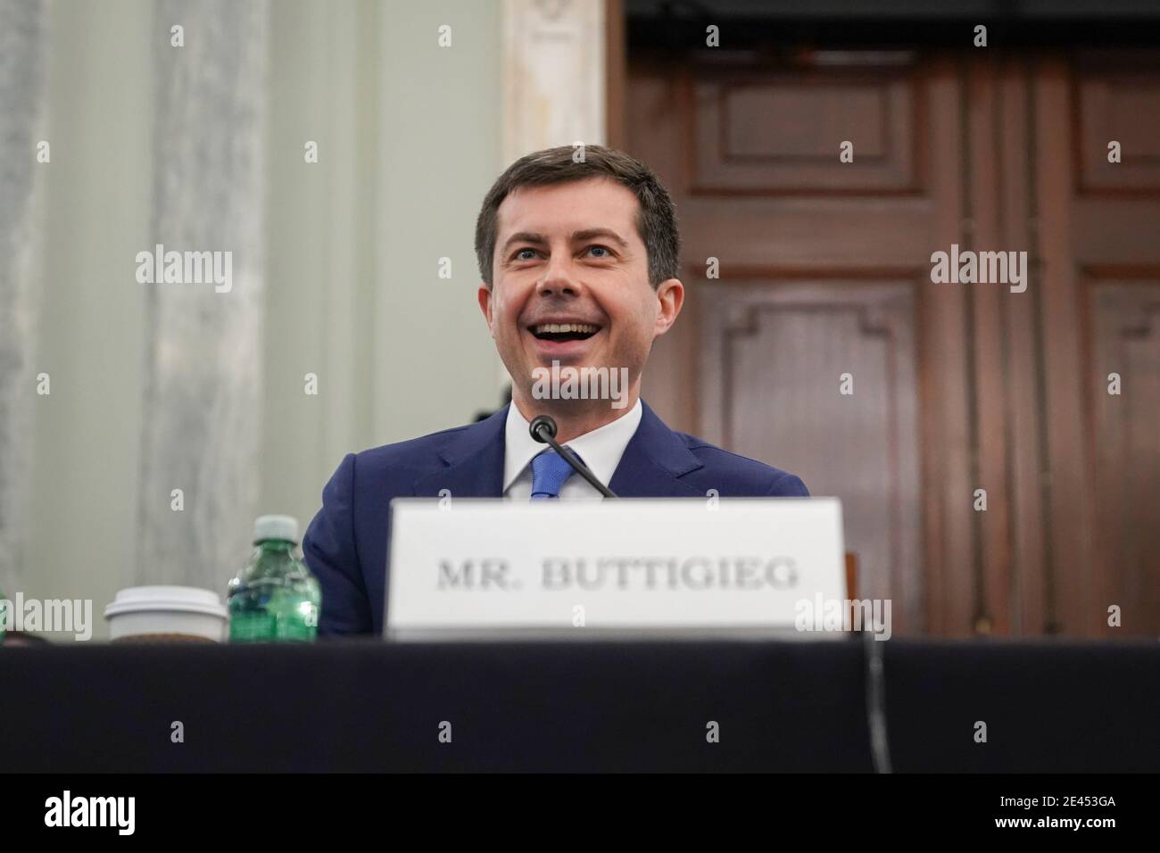 Washington, DC, USA. 21st Jan, 2021. Pete Buttigieg, U.S. secretary of transportation nominee for U.S. President Joe Biden, smiles during a Senate Commerce, Science and Transportation Committee confirmation hearing in Washington, DC, U.S., on Thursday, Jan. 21, 2021. Buttigieg, is pledging to carry out the administration's ambitious agenda to rebuild the n sation's infrastructure, calling it a 'generational opportunity' to create new jobs, fight economic inequality and stem climate change. Credit: Stefani Reynolds/Pool via CNP | usage worldwide Credit: dpa/Alamy Live News Stock Photo