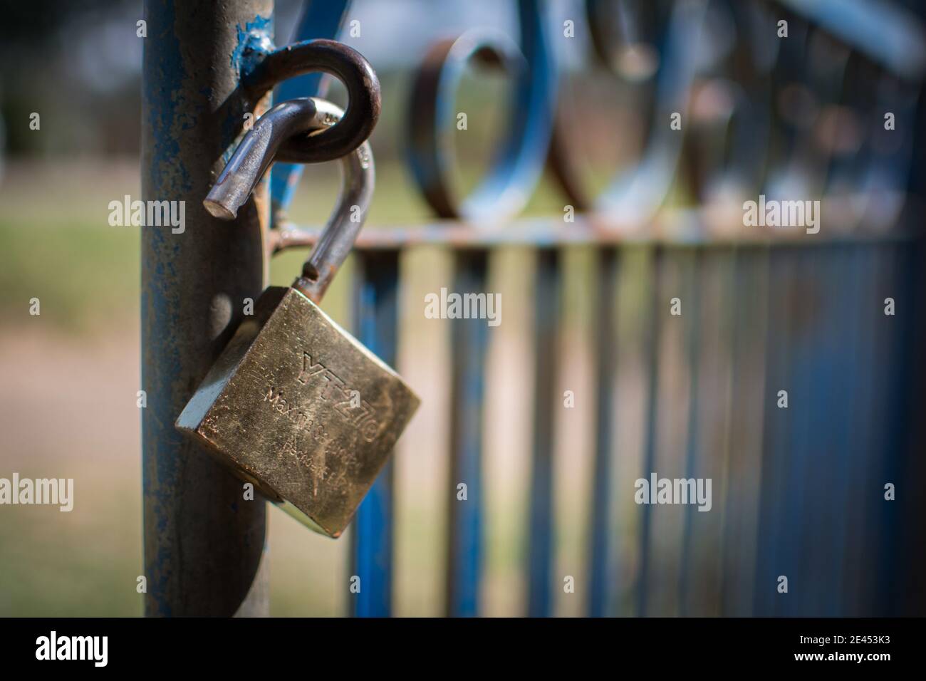 Open lock hanging from rusty chains Stock Photo Alamy