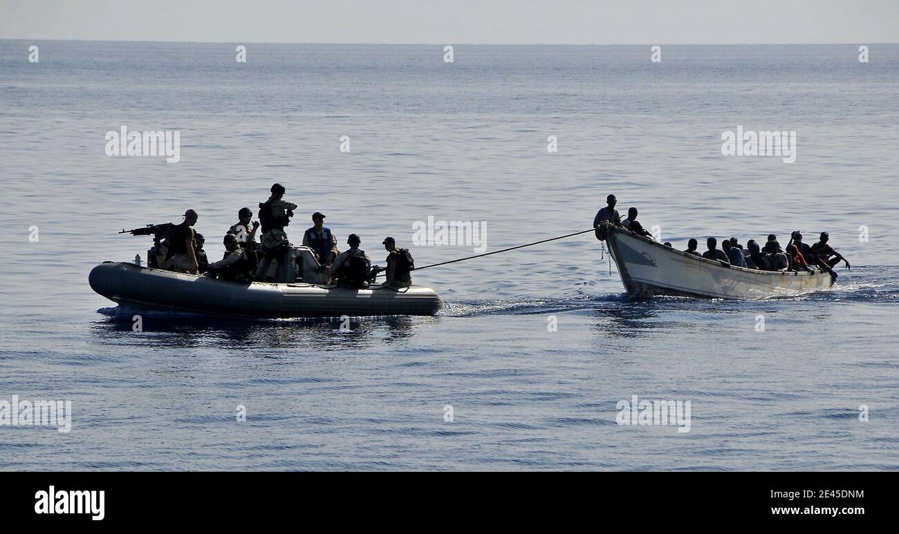 Members of the visit, board, search, and seizure team from the guided-missile cruiser USS Lake Champlain tow a disabled skiff carrying 52 Somali migrants in the Gulf of Aden on May 24, 2009. The skiff was spotted in distress by Lake Champlain helicopter pilots while patrolling the area. Photo by Daniel Barker/USN via ABACAPRESS.COM Stock Photo