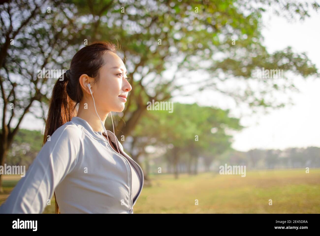 closeup beautiful young woman face before running in the park at  morning Stock Photo