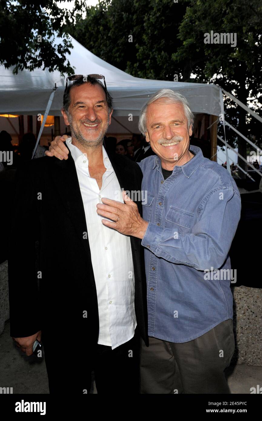 French photographer Yann Arthus-Bertrand (R) and his music composer Armand  Amar prior to the presentation of their movie 'Home' on giant screen  displayed on Champ de Mars garden, underneath the Eiffel Tower