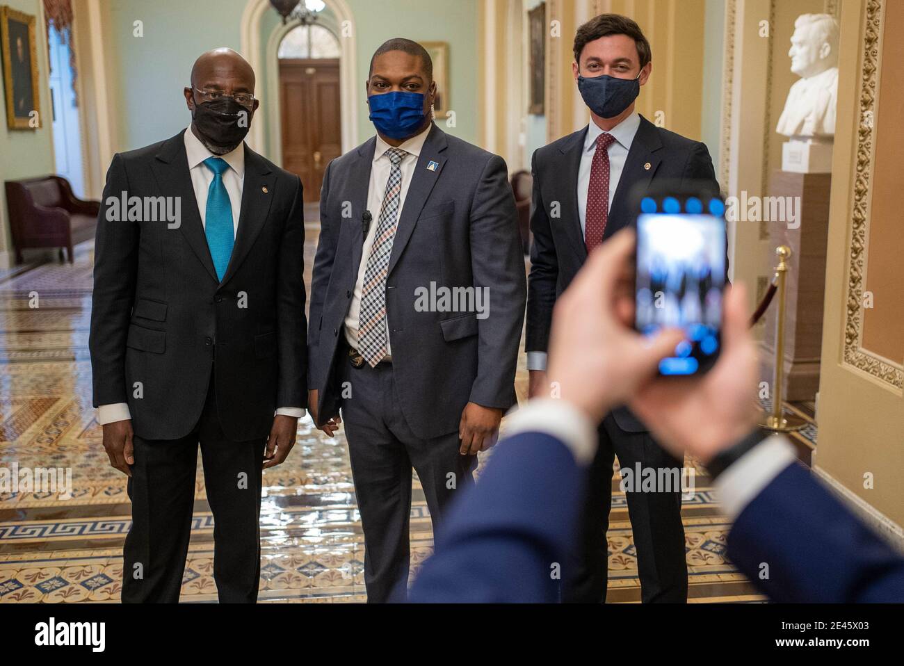 Washington, United States. 21st Jan, 2021. Sen. Raphael Warnock, D-GA, left, and Sen. Jon Ossoff, D-GA, right, pose for a photo with U.S. Capitol Police Officer Eugene Goodman at the U.S. Capitol in Washington, DC on Thursday, January 21, 2021. Goodman was responsible for redirecting Trump-mob supporters away from the Senate chamber during the attack on the U.S. Capitol on January 6. Photo by Ken Cedeno/UPI Credit: UPI/Alamy Live News Stock Photo