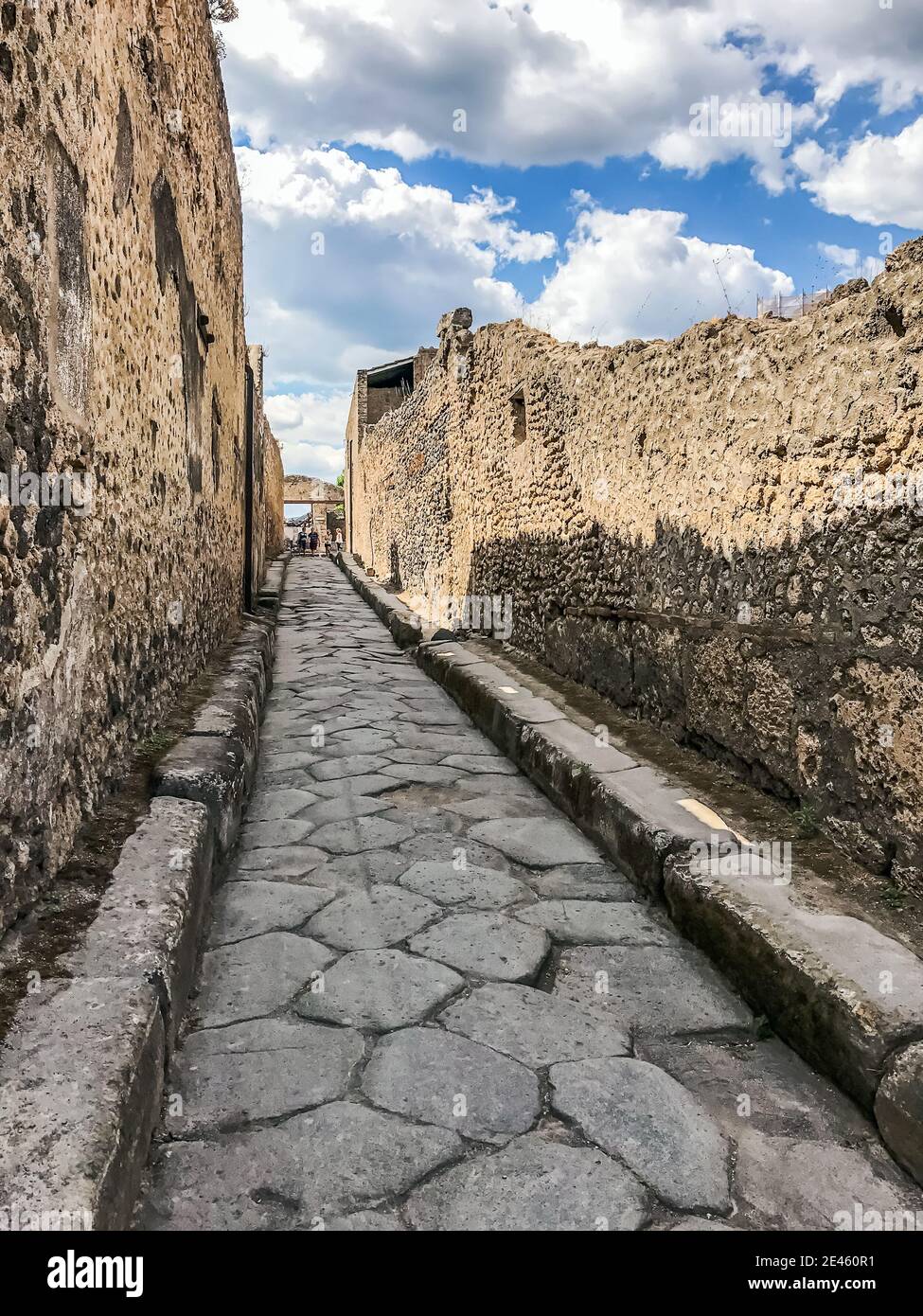 Empty Ancient Roman city of Pompeii under a blue sky with clouds ...