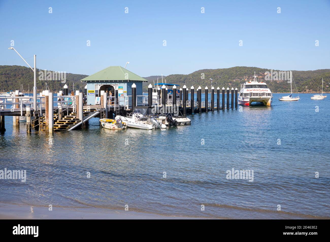 Palm Beach ferry wharf with cruising ferry at the wharf,Pittwater,Sydney,Australia Stock Photo