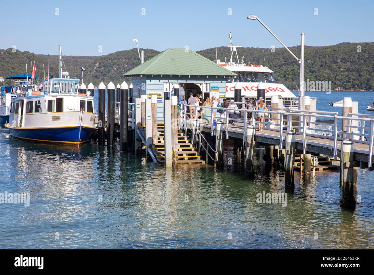 Palm Beach ferry wharf on Pittwater in Sydney northern beaches with passengers waiting to board Fantasea ferry boat,Sydney,NSW,Australia Stock Photo