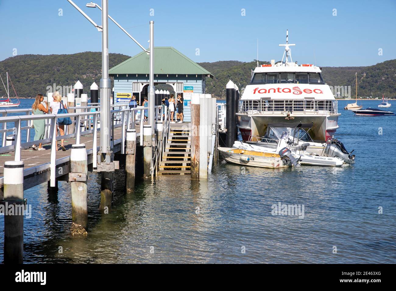 Palm Beach ferry wharf on Pittwater in Sydney northern beaches with passengers waiting to board Fantasea ferry boat,Sydney,NSW,Australia Stock Photo