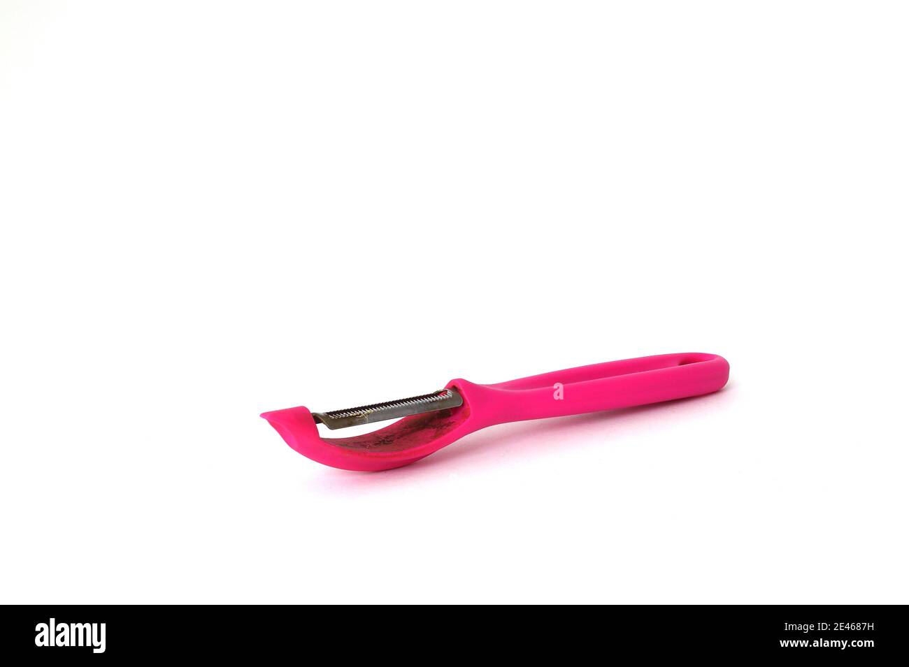 Pink vegetable peeler isolated on white background. Stock Photo