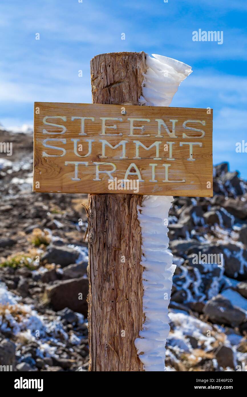 Hard rime ice on Steens Summit Trail sign, formed during a freezing fog and wind atop Steens Mountain, Oregon, USA Stock Photo