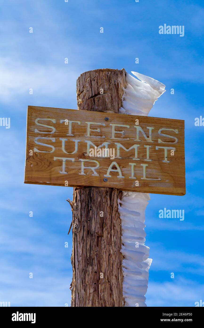 Hard rime ice on Steens Summit Trail sign, formed during a freezing fog and wind atop Steens Mountain, Oregon, USA Stock Photo