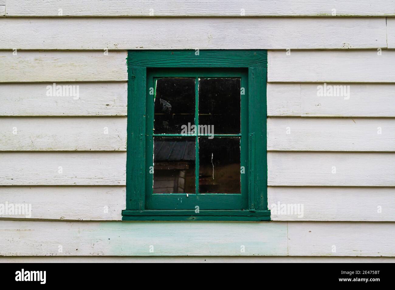 And old window and windows frame painted in green on a building with ...