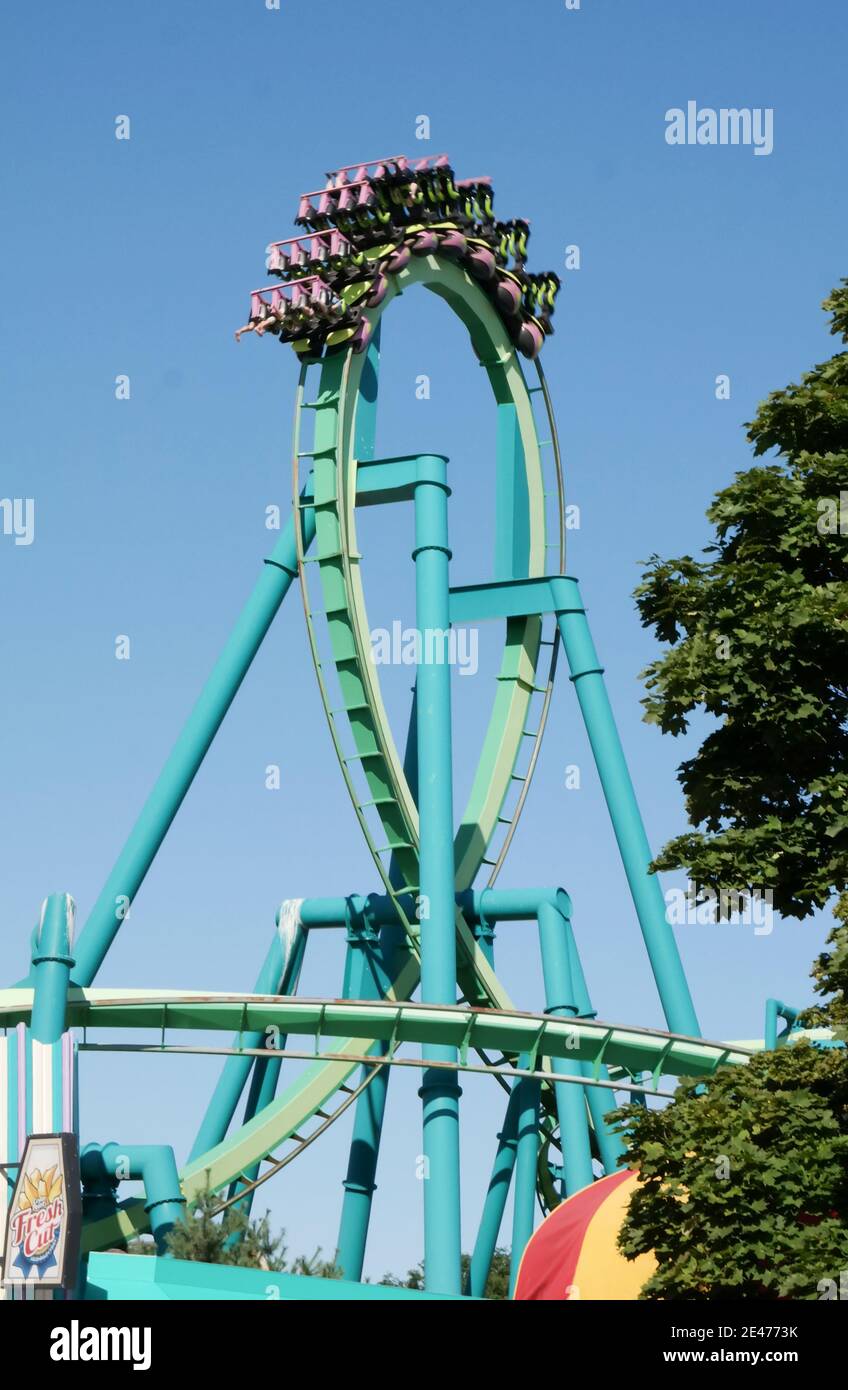 Riders upside down on the loop of the Raptor roller coaster at Cedar Point amusement park in Sandusky, Ohio, USA. Stock Photo