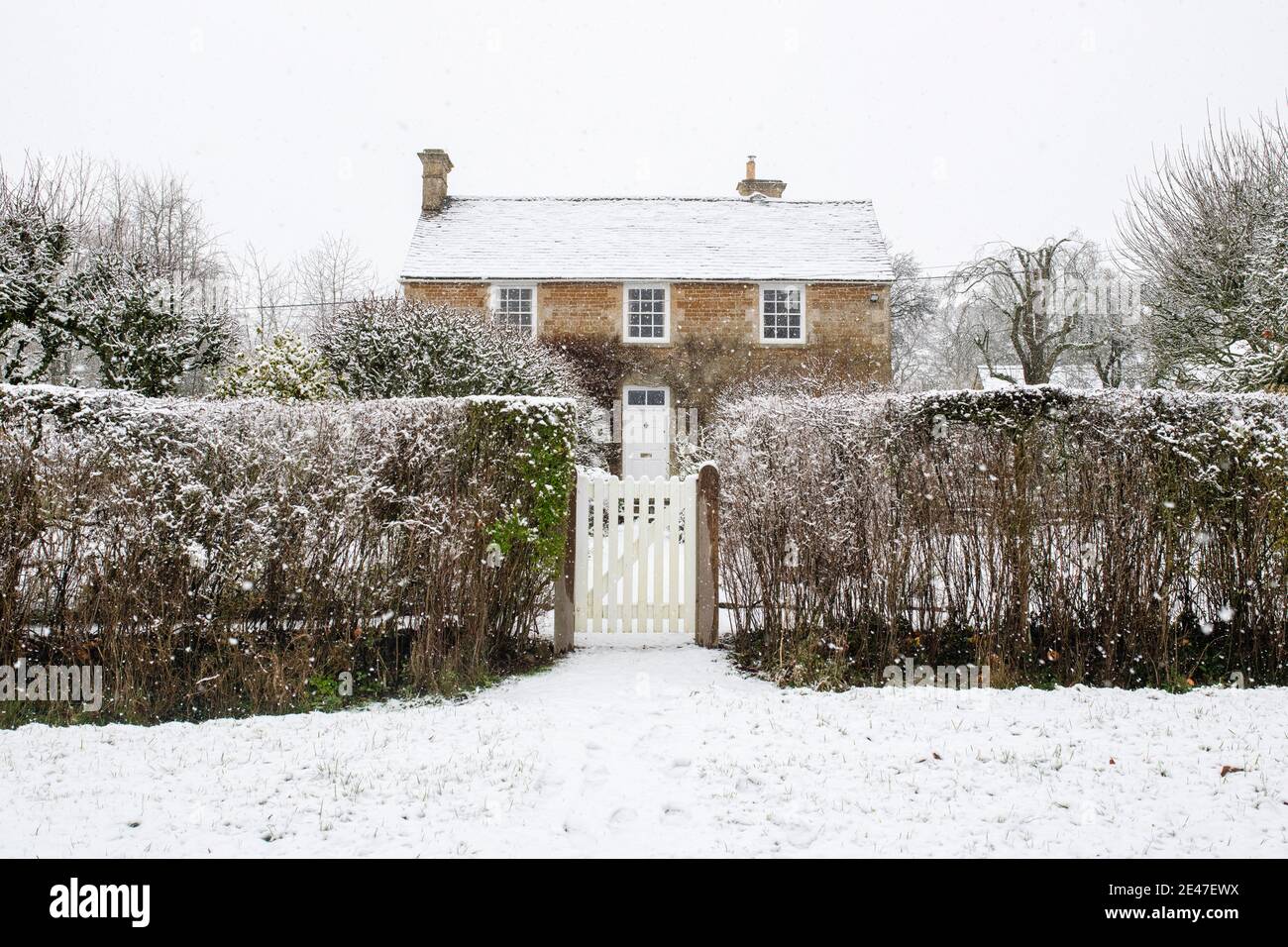 Cotswold stone cottage in the December snow. Wyck Rissington, Cotswolds, Gloucestershire, England Stock Photo