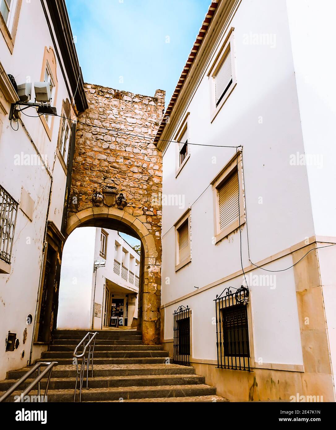 Vertical shot of a narrow street with stairs in Tavira Stock Photo - Alamy