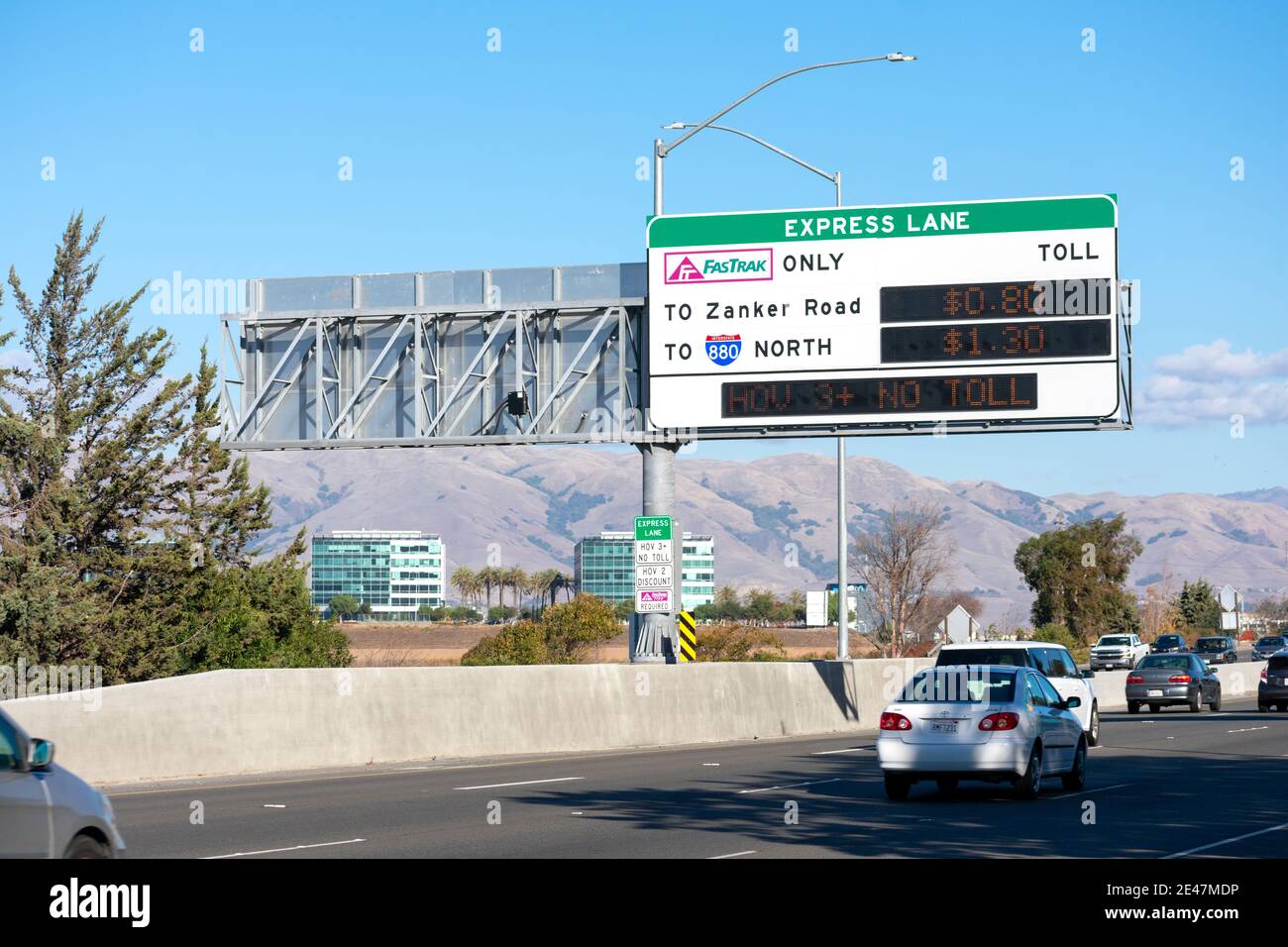 FasTrak express lane sign on highway. FasTrak is an electronic toll collection ETC system on toll roads, bridges, and high-occupancy toll lanes in Cal Stock Photo
