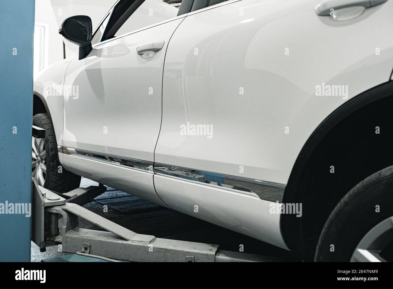White car lifted in automobile service station Stock Photo - Alamy