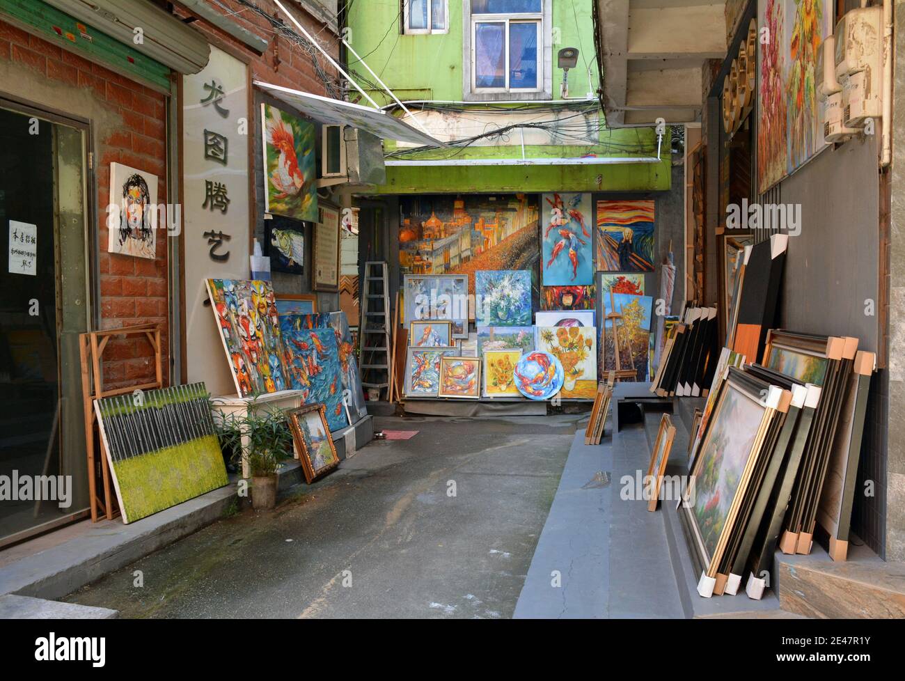 Local artists paint and sell their work on the streets of Dafen oil