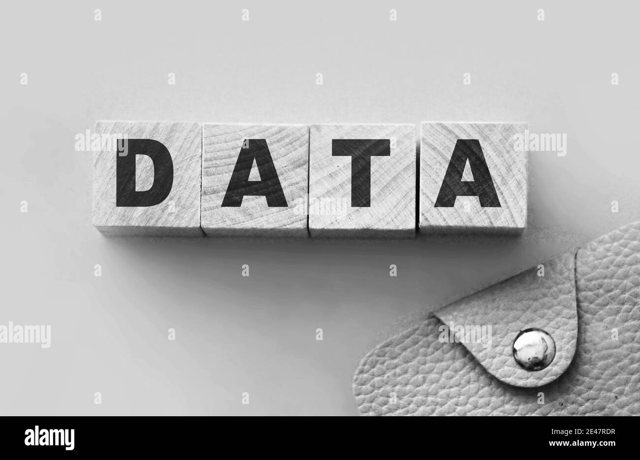 Data word on wooden blocks with letters and pink leather wallet ...