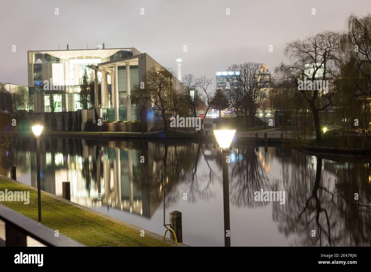 Nighttime view of the illuminated German Chancellery (Bundeskanzleramt) reflecting in the calm waters of the Spree River in Berlin. Stock Photo