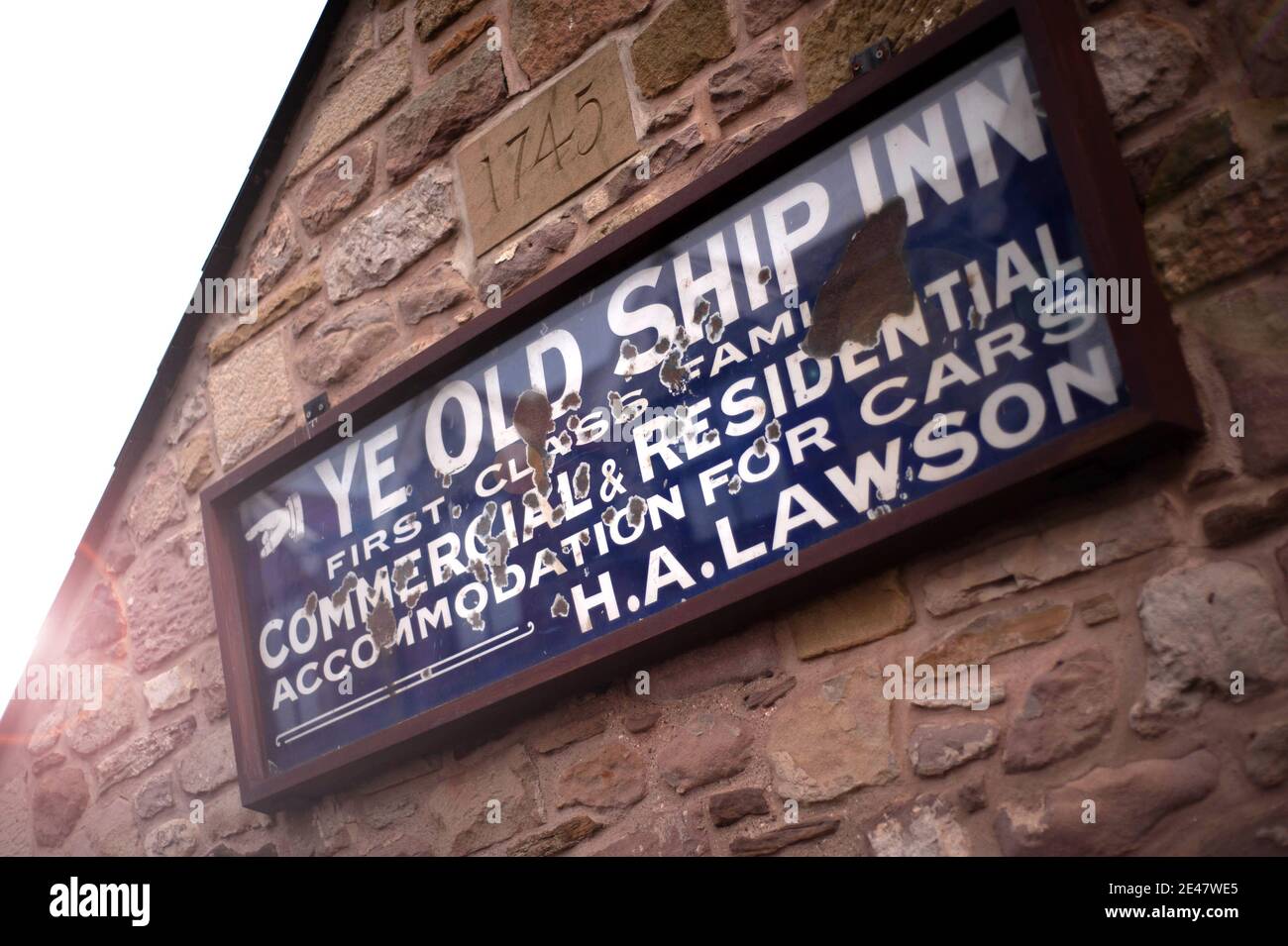 Worn ceramic sign for The Olde Ship. Seahouses Stock Photo