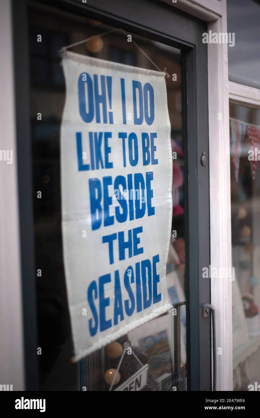 Oh I do like to be beside the seaside poster in Seahouses shop window Stock Photo