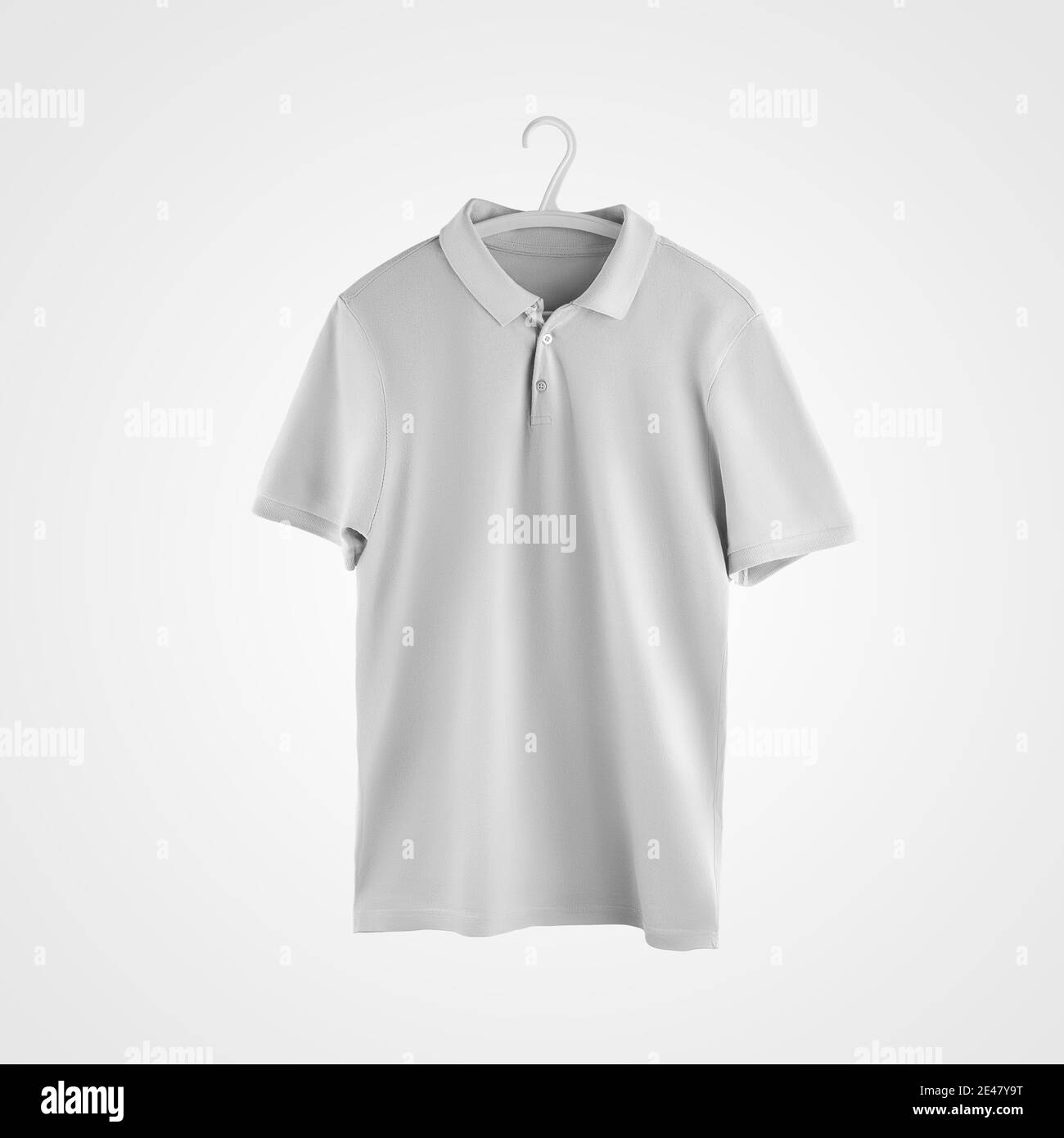 A mockup of a male white polo hanging on a plastic hanger, blank clothes isolated on the background. Casual branded t-shirt template, for design prese Stock Photo