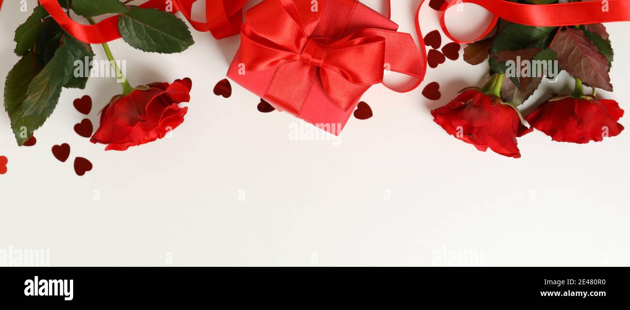Concept of Valentine's day with roses and gift box on white background ...