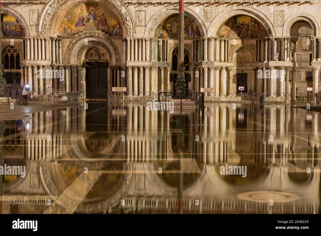 St. Mark's Basilica reflecting in high water flooded St. Mark's Square at night, Venice, Italy Stock Photo