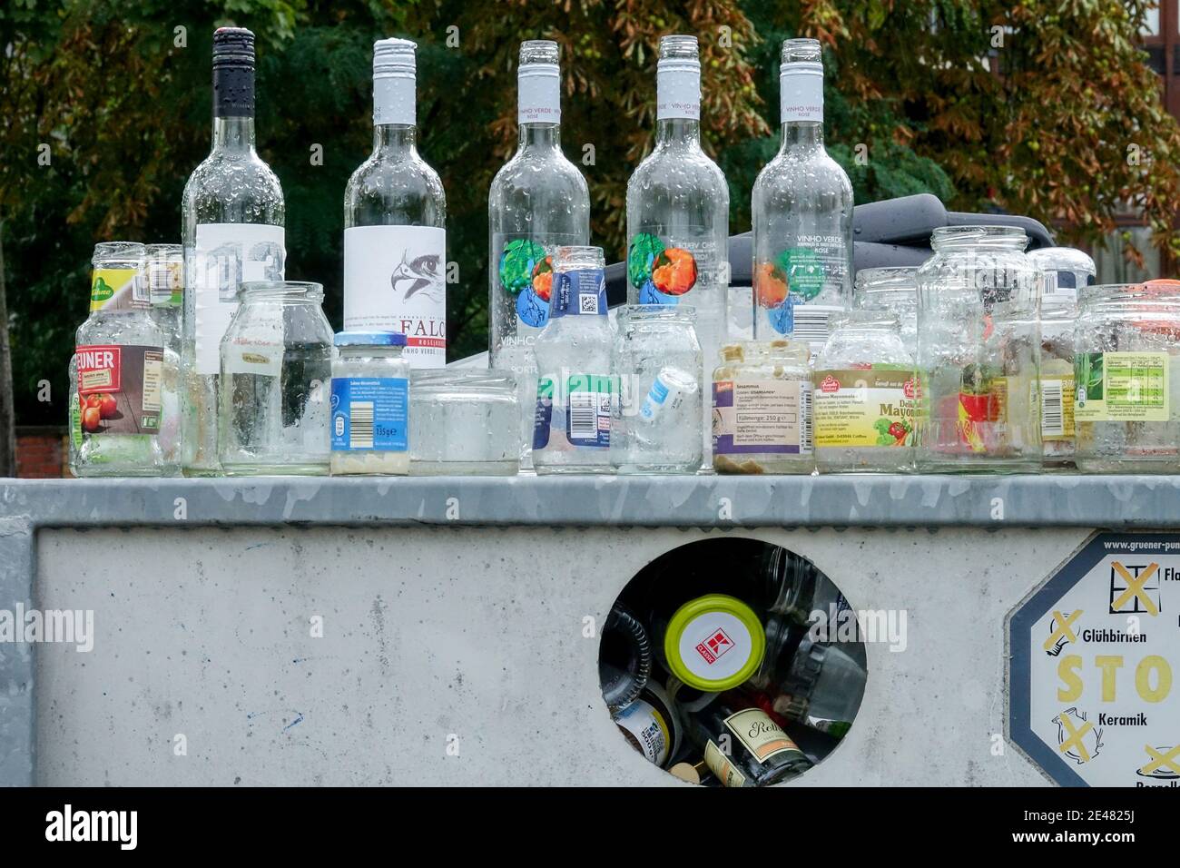 Full container on the used glass. empty bottles recycling box Germany Stock Photo