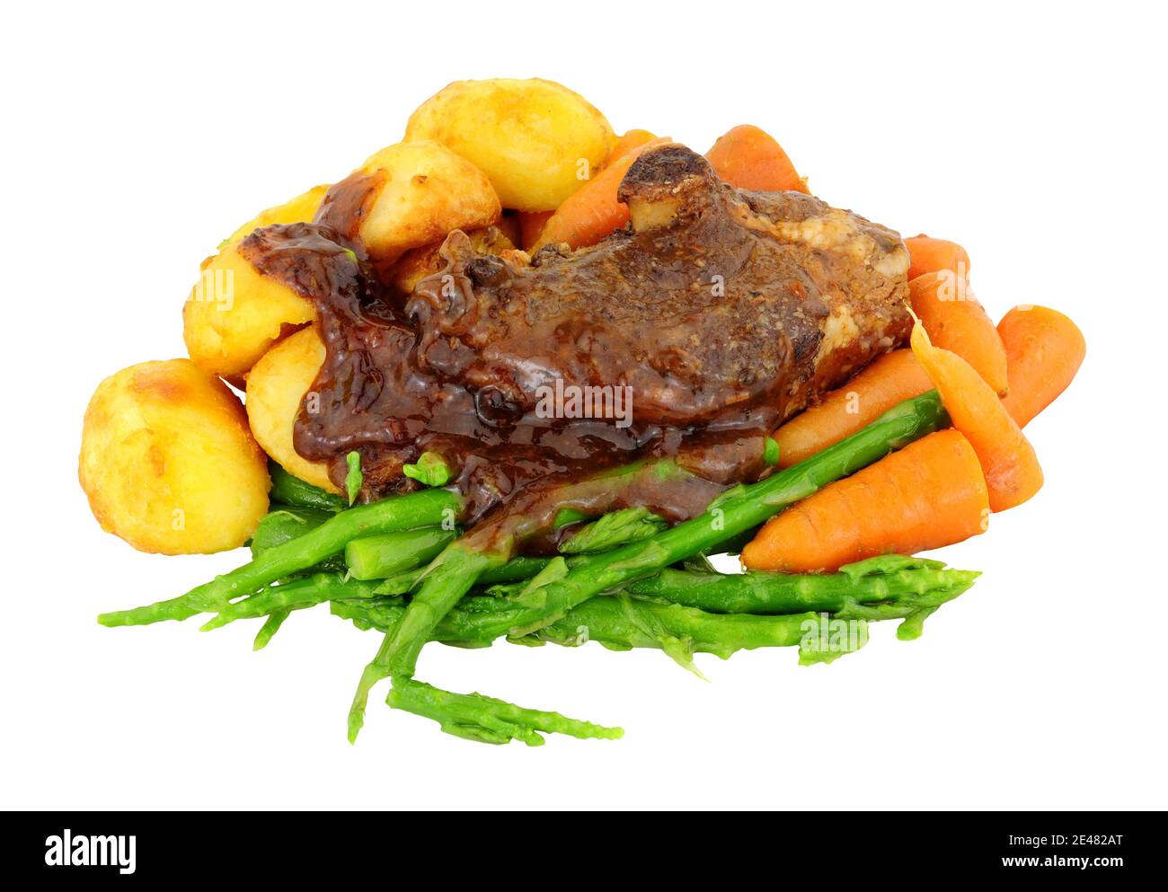 Slow cooked lamb rump joint meal with roast potatoes, baby carrots and