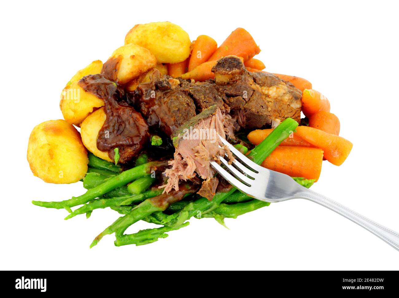 Slow cooked lamb rump joint meal with roast potatoes, baby carrots and