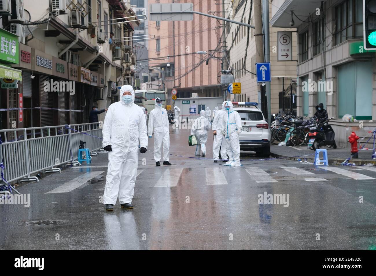 Shanghai.China-Jan.2021: new Covid-19 cases have emerged in China. Region has been locked down. Medical staff in white hazmat suit on street Stock Photo