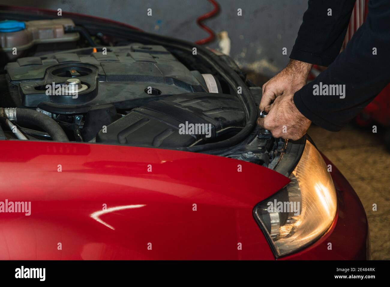 Mechanic's hands repairing car headlight. Concept of automobile