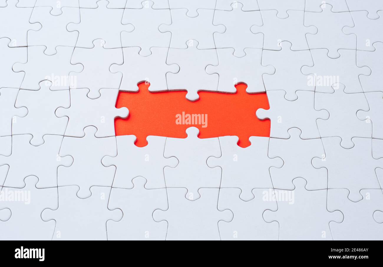 Empty white jigsaw puzzle with missing pieces Stock Photo